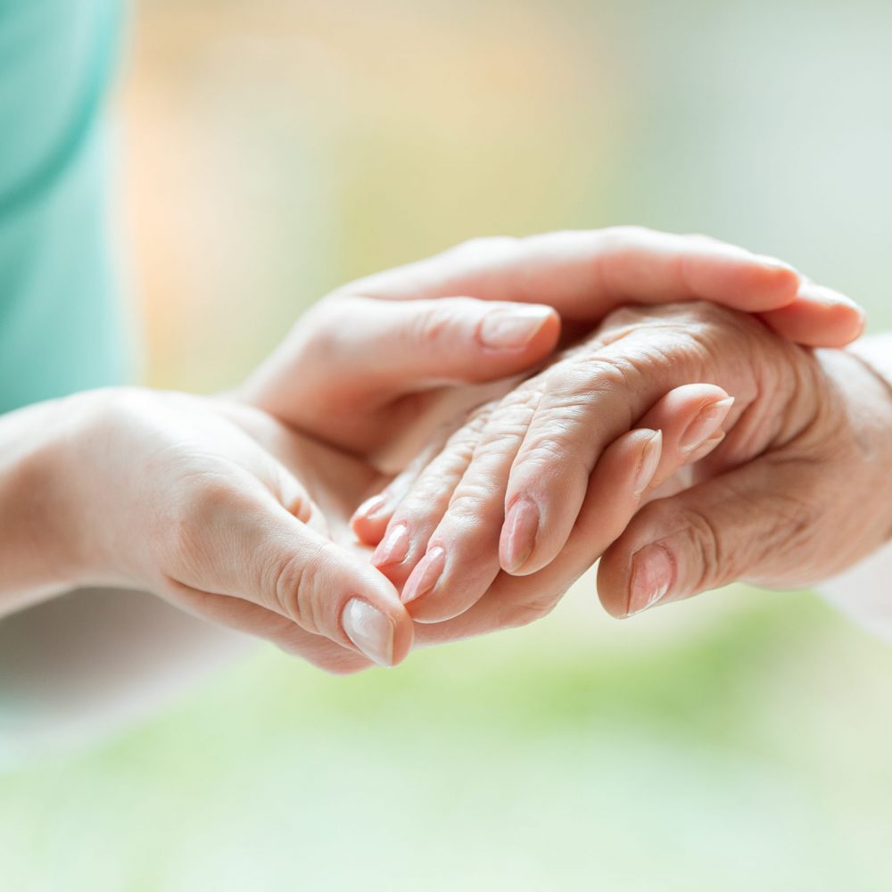 Senior person thanks the nurse for help during a meeting in a nursing home